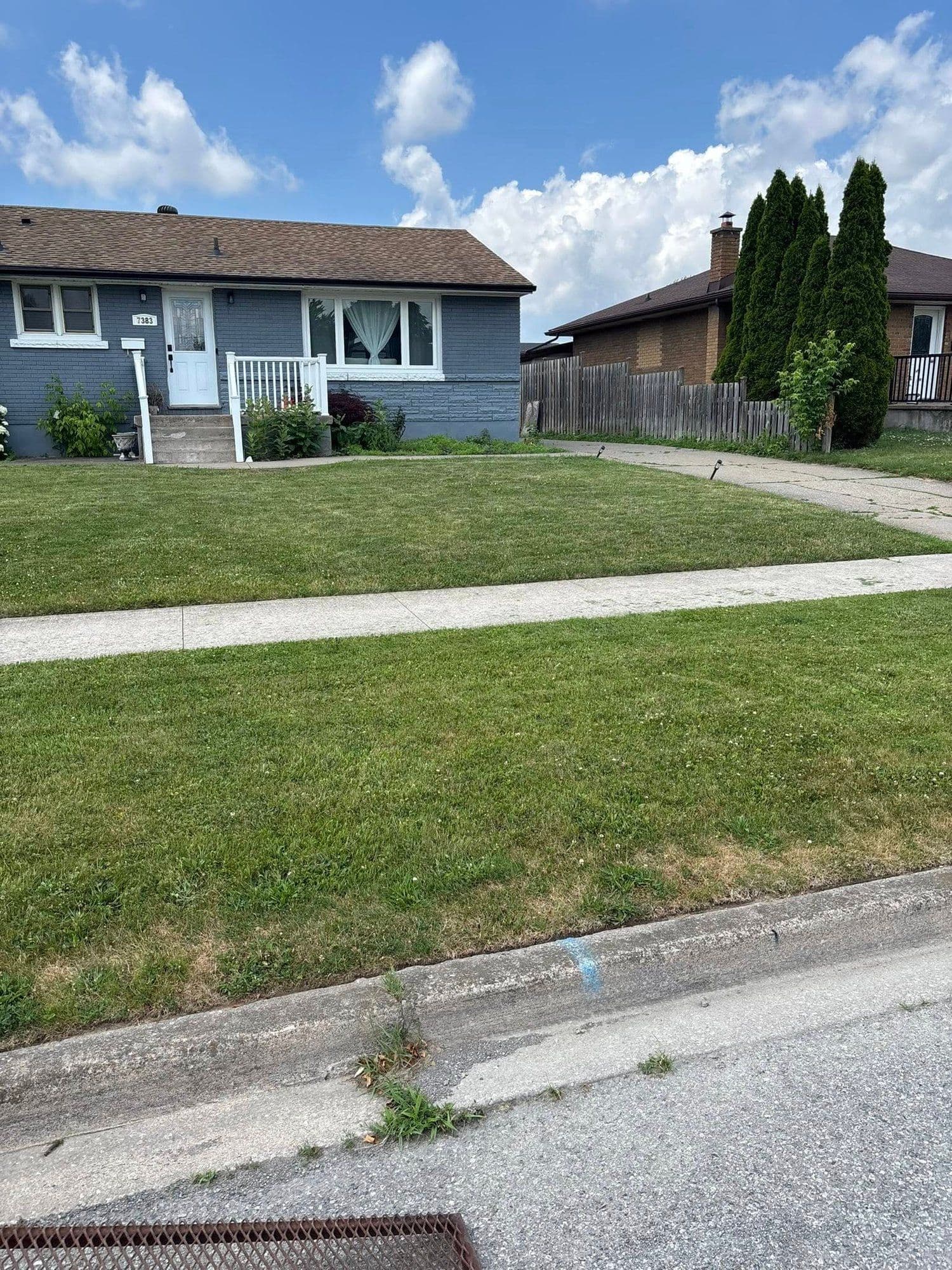 Trimmed front lawn of a residential bungalow